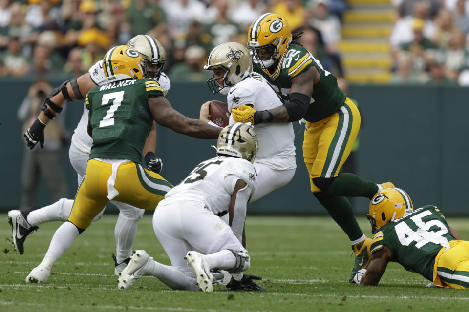New Orleans Saints quarterback Derek Carr (4) is sacked during the second half of an NFL football game against the Green Bay Packers Sunday, Sept. 24, 2023, in Green Bay, Wis. (AP Photo/Matt Ludtke)