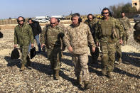 FILE - In this Jan. 25, 2020, file photo, Gen. Frank McKenzie, center front, the top U.S. commander for the Middle East, walks as he visits a military outpost in Syria. Syria’s civil war has long provided a free-for-all battlefield for proxy fighters. But in its ninth year, the war is drawing major foreign actors into direct conflict, with the threat of all-out confrontations becoming a real possibility. (AP Photo/Lolita Baldor, File)