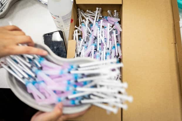 Nurses with Humber River Hospital prepare doses of the Moderna COVID-19 vaccine at a mobile clinic in Toronto on Apr. 13, 2021.