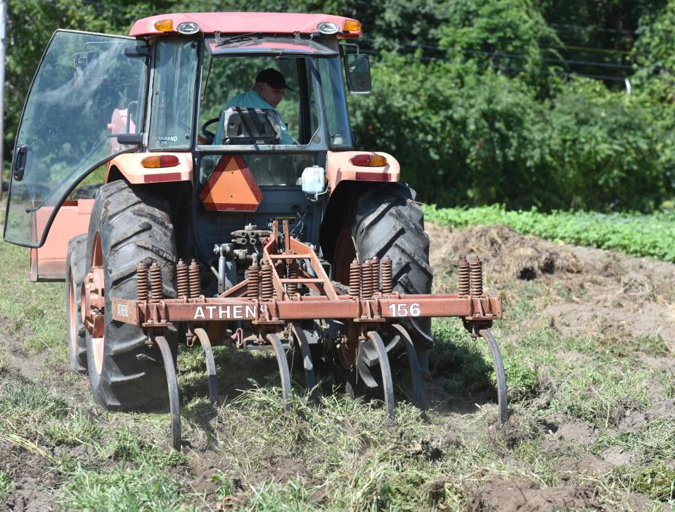 Cape Cod Organic Farm's Tim Friary plows through the dry soil at his Barnstable farm recently as he prepares to seed the field with an over winter crop to nourish the soil. The drought conditions this summer have hurt the yield of his crops. Steve Heaslip/Cape Cod Times