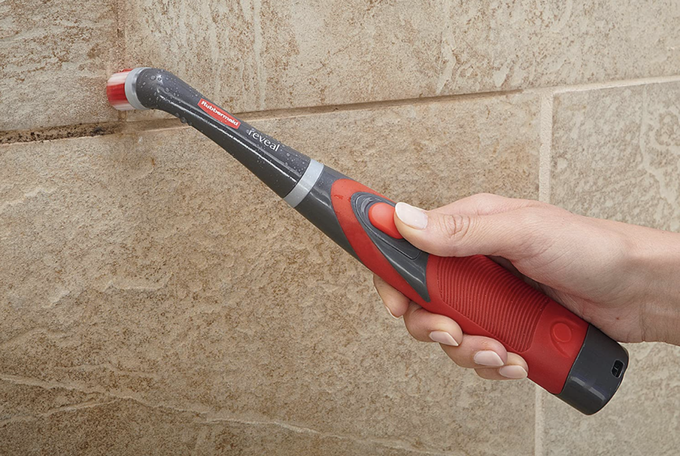 the rubbermaid reveal power scrubber being used to clean grout