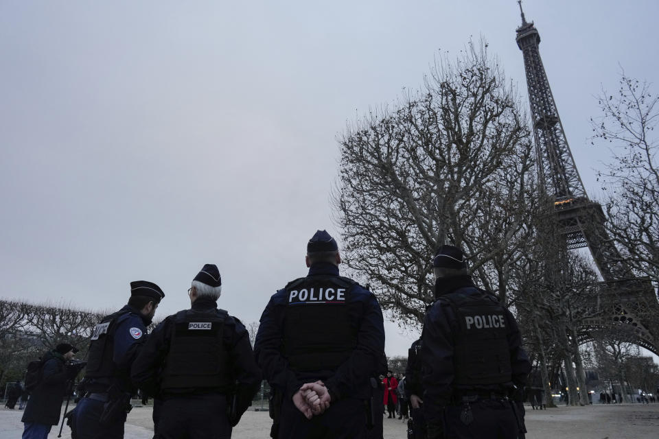 French policemen patrol around the Eiffel Tower, in Paris, Thursday, Dec. 7, 2023. Less than a year before the 2024 Paris Olympic Games, with an opening ceremony on the nearby Seine river, the bar was already high. But the security challenge went up with the deadly weekend knife attack that killed a tourist near the Eiffel Tower, a tourist magnet that is the symbol of Paris. (AP Photo/Thibault Camus)