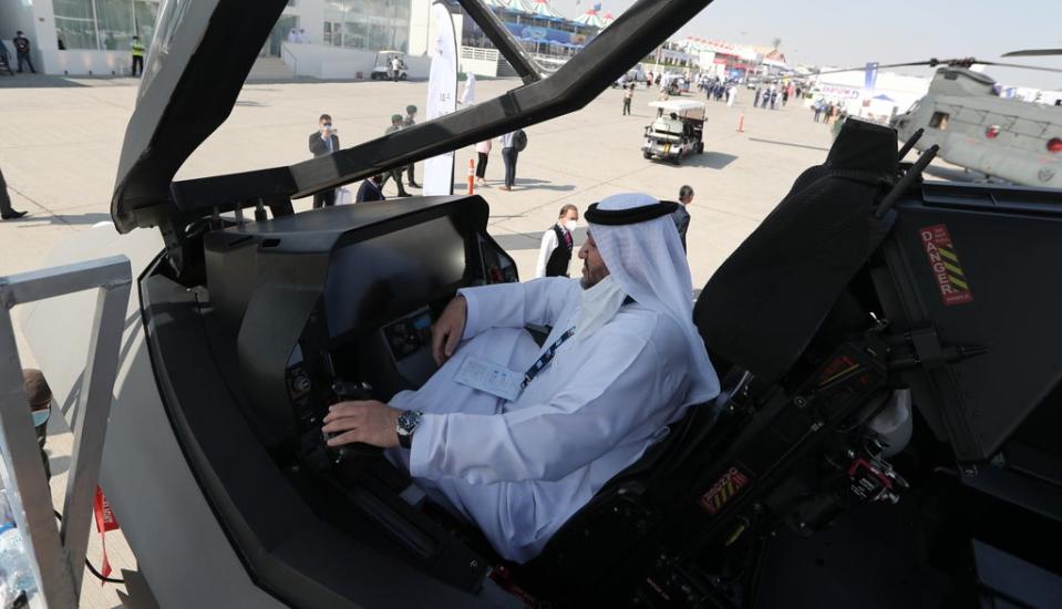 An Emirati inspects the US F-35 during the exhibition of the Dubai Airshow 2021 (EPA)