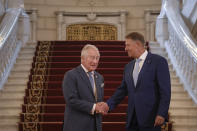 Britain's Prince Charles, left, shakes hands with Romanian President Klaus Iohannis at the Cotroceni Presidential Palace, in Bucharest, Romania, Wednesday, May 25, 2022.(AP Photo/Andreea Alexandru)