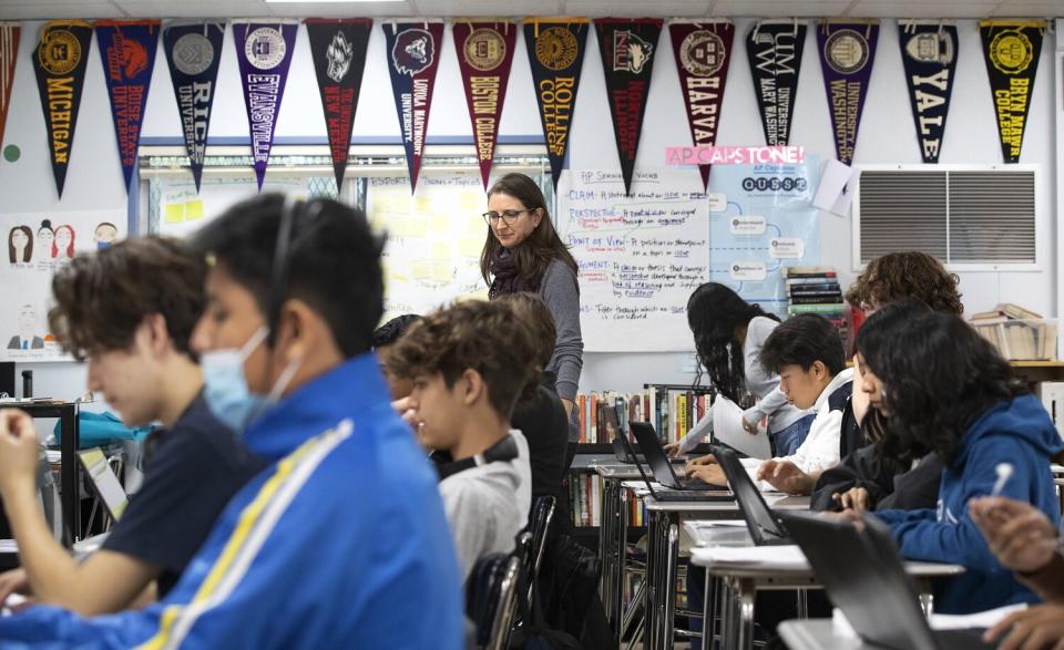 A teacher watches students during class.