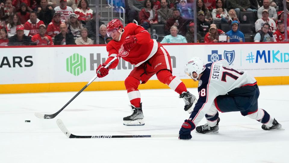 Detroit Red Wings right wing Daniel Sprong (88) shoots to score as Columbus Blue Jackets defenseman Damon Severson (78) defends in the second period of an NHL hockey game Saturday, Nov. 11, 2023, in Detroit. (AP Photo/Paul Sancya)