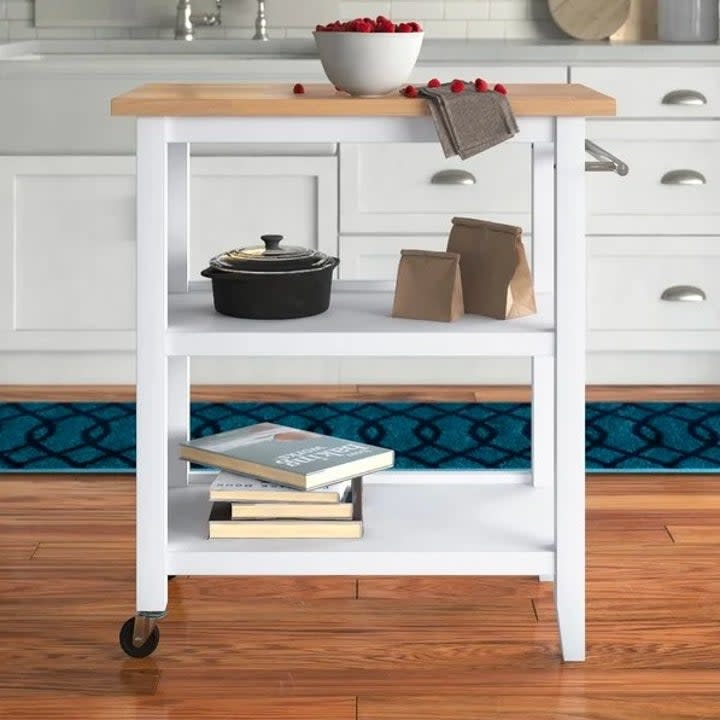 White kitchen island styled with various kitchen items