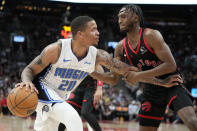 Toronto Raptors guard Immanuel Quickley, right, defends against Orlando Magic guard Markelle Fultz (20) during the second half of an NBA basketball game Friday, March 15, 2024, in Toronto. (Frank Gunn/The Canadian Press via AP)