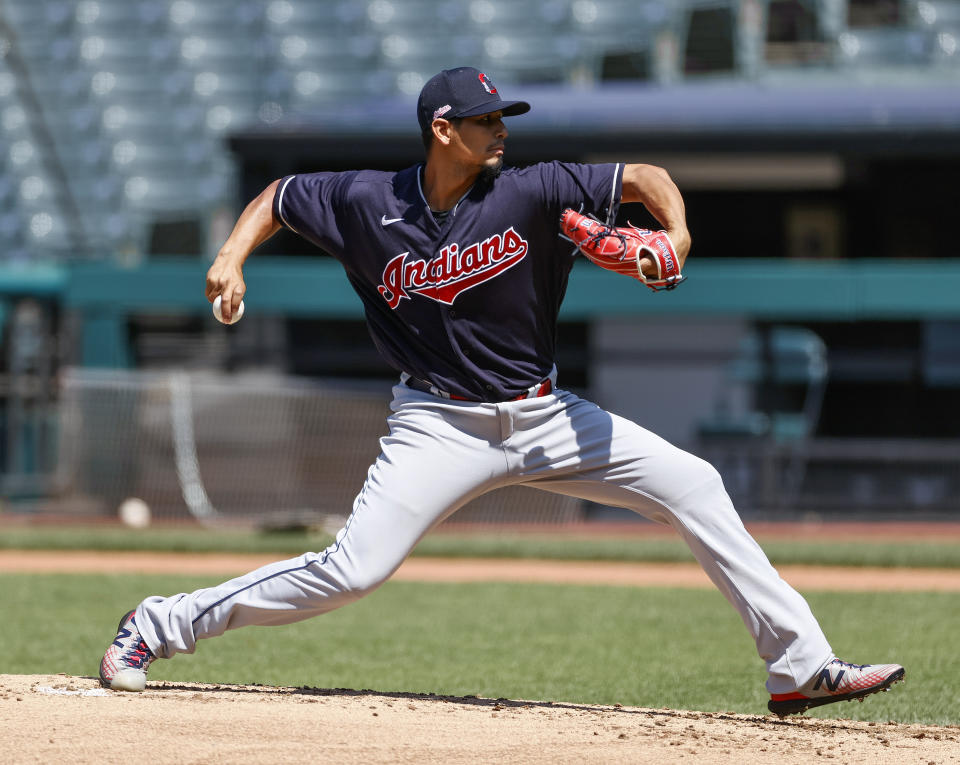 Cleveland Indians starting pitcher Carlos Carrasco pitches during baseball practice at Progressive Field, Monday, July 6, 2020, in Cleveland. (AP Photo/Ron Schwane)