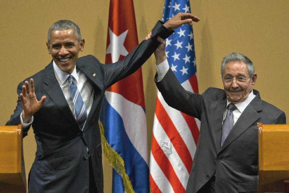 FILE - In this March 21, 2016, file photo, Cuban President Raul Castro, right, lifts up the arm of President Barack Obama at the conclusion of their news conference at the Palace of the Revolution in Havana, Cuba. Obama's foreign policy legacy may be defined as much by what he didn't do as what he did. (AP Photo/Ramon Espinosa, File)