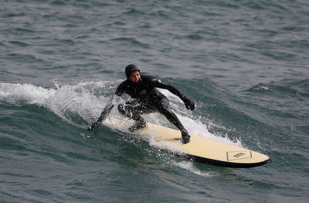 Australian Olympic team member Danielle Scott surfs a wave in Gangneung, South Korea, February 24, 2018. REUTERS/Kim Hong-Ji