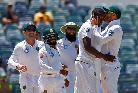 Cricket - Australia v South Africa - First Test cricket match - WACA Ground, Perth, Australia - 7/11/16. South Africa's Kagiso Rabada is kissed by team captain Faf du Plessis as they celebrate dismissing Australia's Mitchell Starc at the WACA Ground in Perth. REUTERS/David Gray