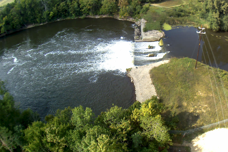 In this Sept 13, 2018 photo provided by the Environmental Protection Agency shows an aerial view of the Trowbridge Dam on the Kalamazoo River near Allegan, Mich., in southwestern Michigan. The aging dam will be taken down under an agreement reached between federal officials and NCR Corp., one of the companies whose paper mills polluted the river with toxic PCBs in the last century. (Paul Ruesch/Environmental Protection Agency via AP)