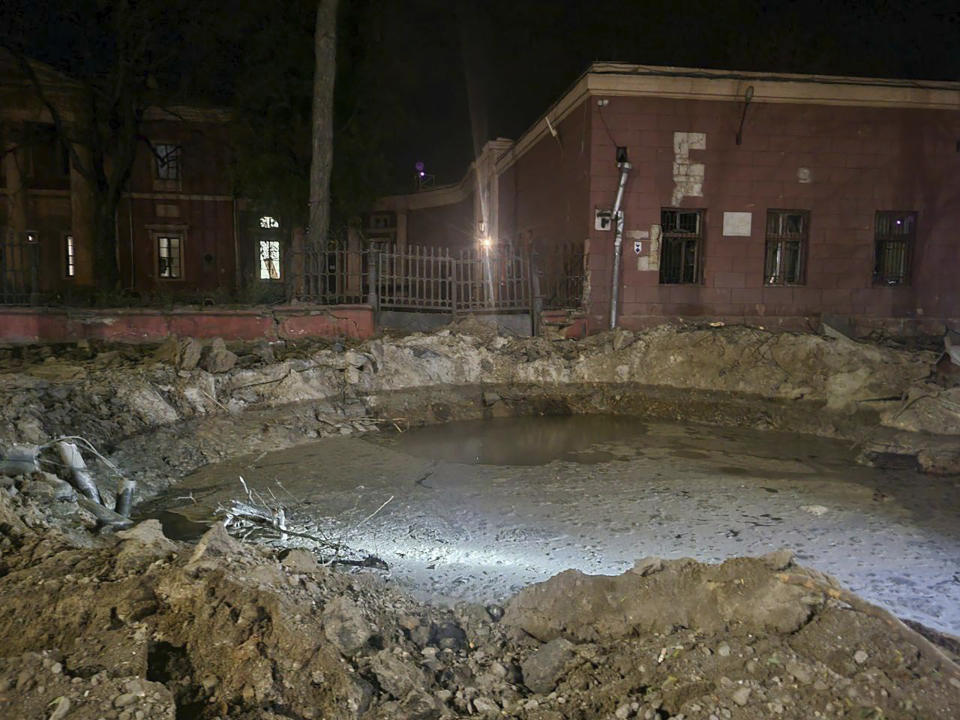 In this photo provided by Odesa City Administration, a crater left by a Russian rocket attack is seen in central Odesa, Ukraine, early hours on Monday, Nov. 6, 2023. (Odesa City Administration via AP)