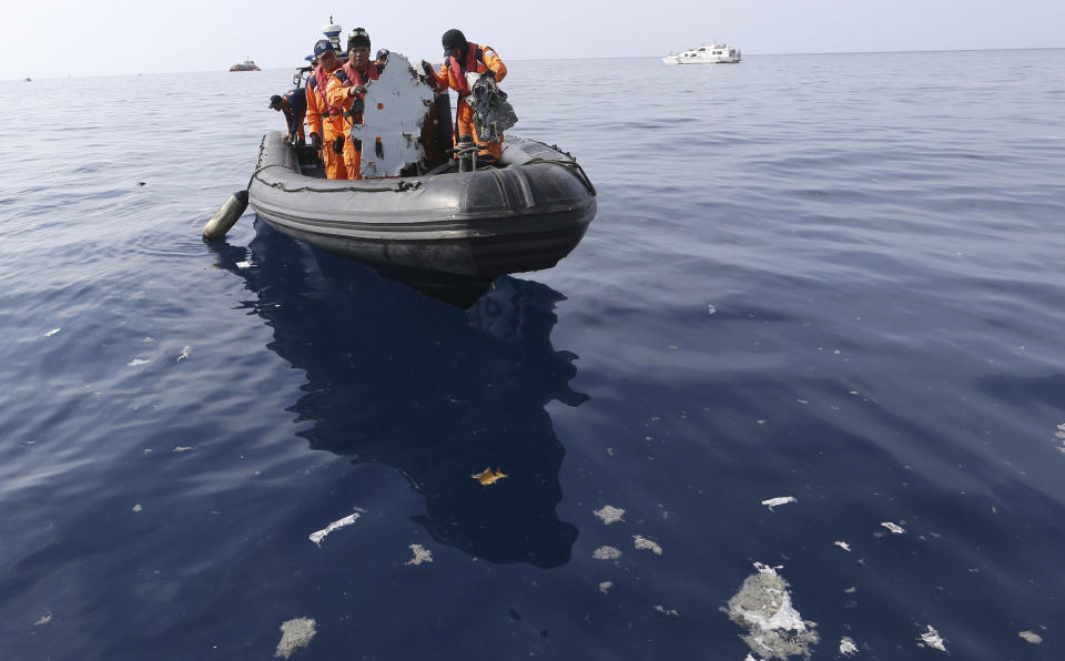 In this Oct 29, 2018, photo, rescuers recover a piece of airplane part from Lion Air flight 610 that crashed into the sea during a rescue operation in the waters of Tanjung Karawang, Indonesia. More families of victims of the Lion Air crash in Indonesia are suing Boeing Co. after its chief executive apologized last week and said a software update for the MAX 8 jet would prevent further disasters. (AP Photo/Achmad Ibrahim)