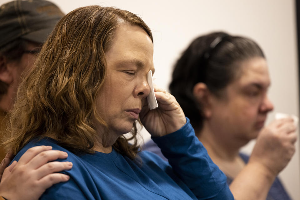 Family members of Robin Edwards, who did not wish to be identified individually, wipe their eyes during a press conference in Suffolk, Virginia, on Jan. 8, 2024. Edwards, 14, was last seen with David Knobling, 20, before their remains were discovered along the shoreline of the Ragged Island Wildlife Refuge in 1987. They had been shot. (Billy Schuerman/The Virginian-Pilot via AP)