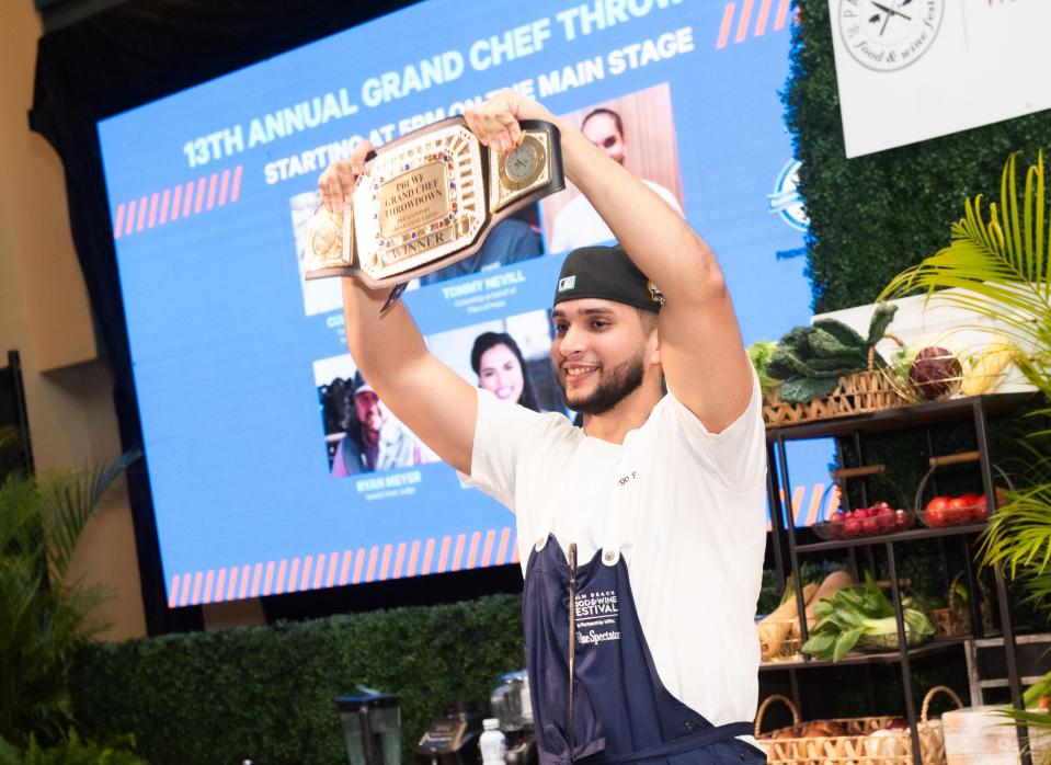 Sunday Grand Tasting: Chef Diego Suero of Honeybelle restaurant holds up his prize belt after winning the Grand Chef Throwdown during the 2023 Palm Beach Food & Wine Festival.