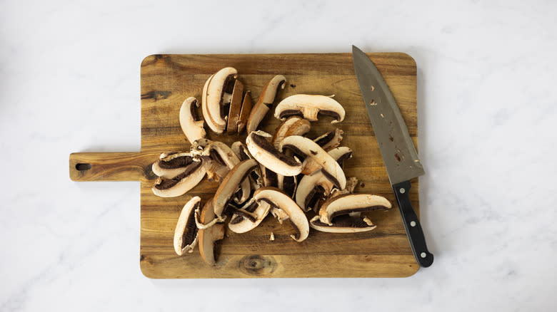 sliced mushrooms on chopping board