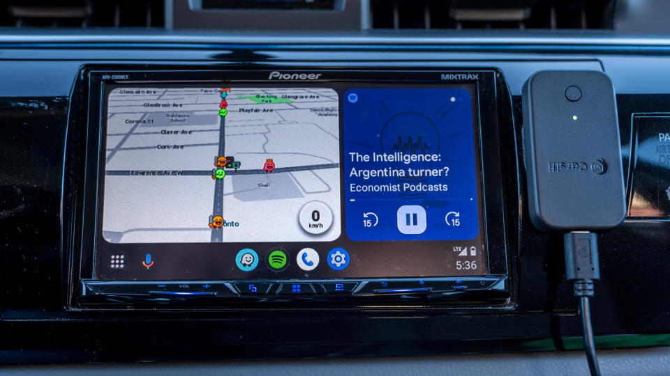 Carsifi Android Auto adapter next to Android Auto screen front view.