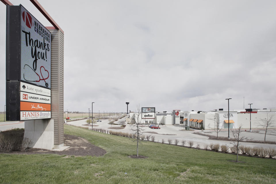 The Nebraska Crossing Outlet shopping mall is seen in Gretna, Neb., Tuesday, April 14, 2020. The outlet mall near Omaha plans to reopen later this month even as the number of coronavirus cases and deaths continues to grow in the state. The owner of the Nebraska Crossing Outlets says their experience will be a case study of best practices for other malls although it is not immediately clear how many stores will reopen when the mall does. (AP Photo/Nati Harnik)