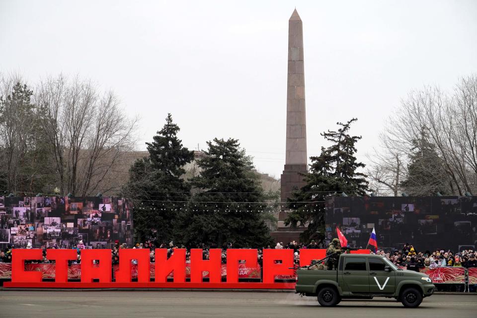 Servicemen ride in a military pickup adorned with the letter V, a tactical insignia of Russian troops in Ukraine, during the Stalingrad parade (AFP/Getty)