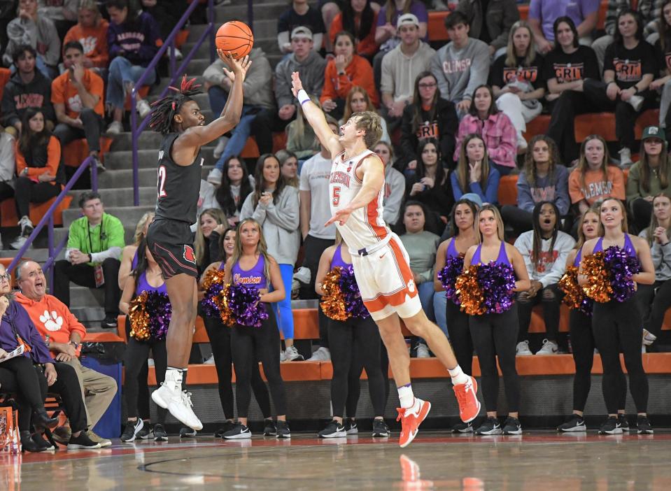 Jan 11, 2023; Clemson, South Carolina, USA; Louisville Cardinals forward Kamari Lands (22) shoots near Clemson Tigers forward Hunter Tyson (5) for three-points during the second half at Littlejohn Coliseum. Mandatory Credit: Ken Ruinard-USA TODAY Sports