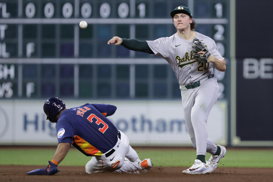 Oakland Athletics second baseman Zack Gelof, left, turns a double play over Houston Astros' Jeremy Pena (3) during the sixth inning of a baseball game Wednesday, May 15, 2024, in Houston. (AP Photo/Michael Wyke)