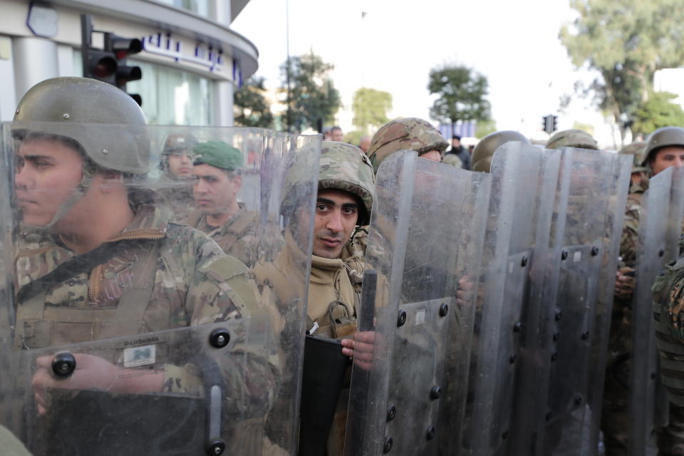 Army soldiers stand guard at a road leading to the parliament building, in downtown Beirut, Lebanon, Monday, Jan. 27, 2020. Lebanese security forces scuffled Monday with protesters near the parliament building in downtown Beirut where lawmakers are scheduled to begin a two-day discussion and later approval of the budget amid a crippling financial crisis. (AP Photo/Hassan Ammar)