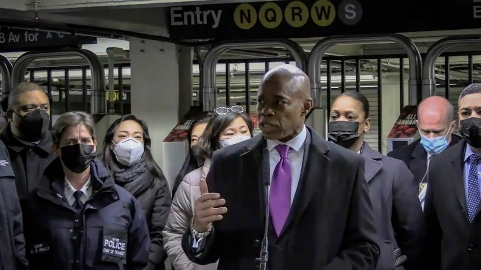 In this livestream frame grab from video provided by NYPD News, Mayor Eric Adams, foreground, with city law officials, speaks at a news conference inside a subway station