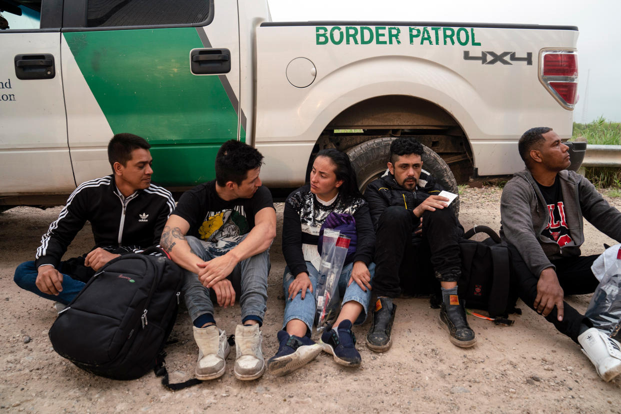 Colombian migrants that were trying to evade the U.S. Border Patrol wait to be processed near the port of entry in Hidalgo, Texas (Veronica G. Cardenas / AP)