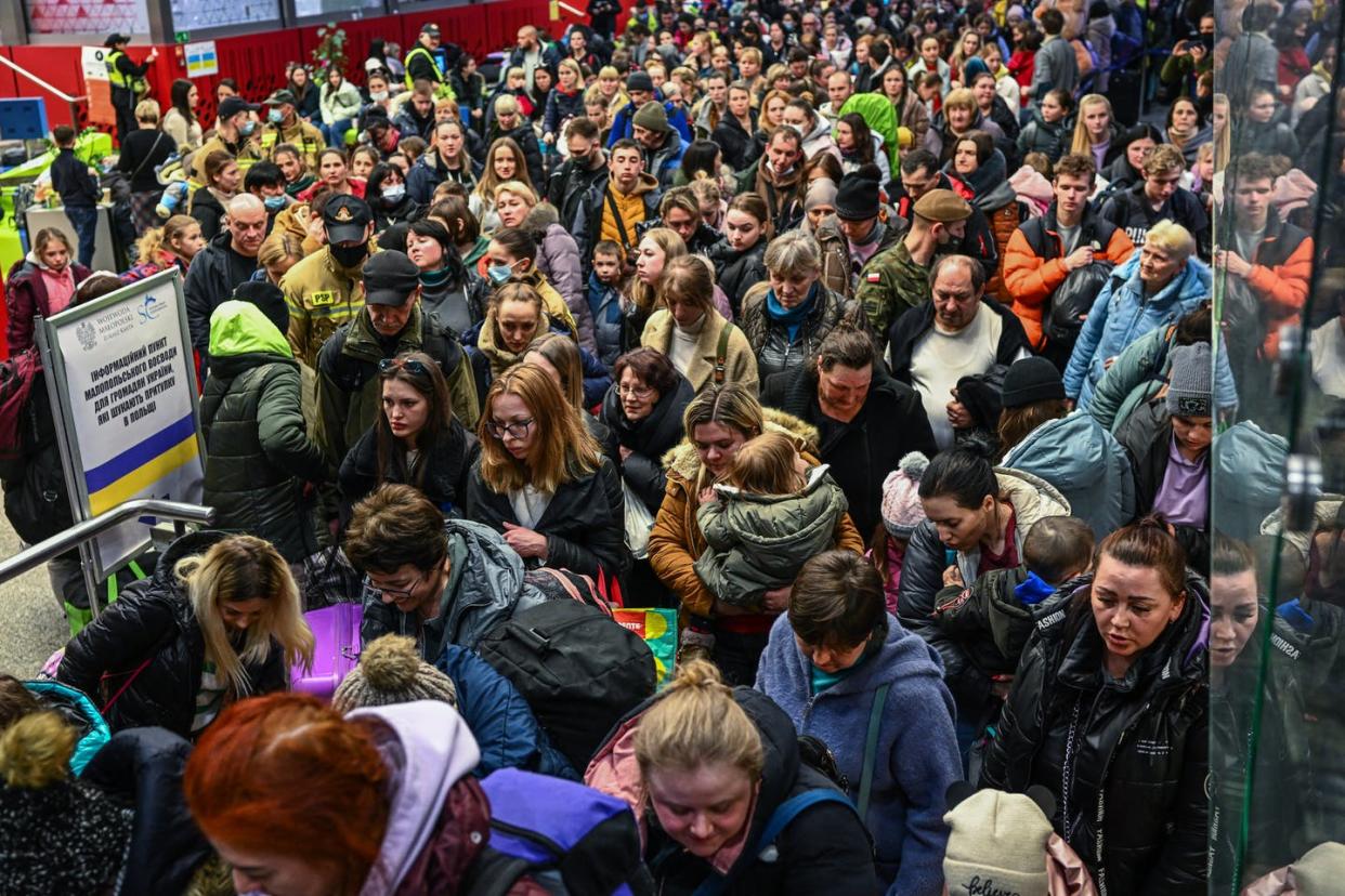 <span class="caption">Ukrainians fleeing the war walk toward a train in Krakow to bring them to Berlin on March 15, 2022. </span> <span class="attribution"><a class="link " href="https://media.gettyimages.com/photos/people-who-fled-the-war-in-ukraine-walk-towards-a-humanitarian-train-picture-id1385521272?s=2048x2048" rel="nofollow noopener" target="_blank" data-ylk="slk:Omar Marques/Getty Images;elm:context_link;itc:0;sec:content-canvas">Omar Marques/Getty Images</a></span>