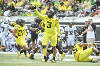 Oregon defensive end Brandon Dorlus (3) celebrates a stop against Portland State during the first half of an NCAA college football game Saturday, Sept. 2, 2023, in Eugene, Ore. (AP Photo/Andy Nelson)