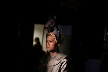 A dancer waits backstage during a performance of masked theatre known as Khon which was recently listed by UNESCO, the United Nations' cultural agency, as an intangible cultural heritage, along with neighbouring Cambodia's version of the dance, known as Lakhon Khol at the Thailand Cultural Centre in Bangkok, Thailand November 7, 2018. REUTERS/Jorge Silva