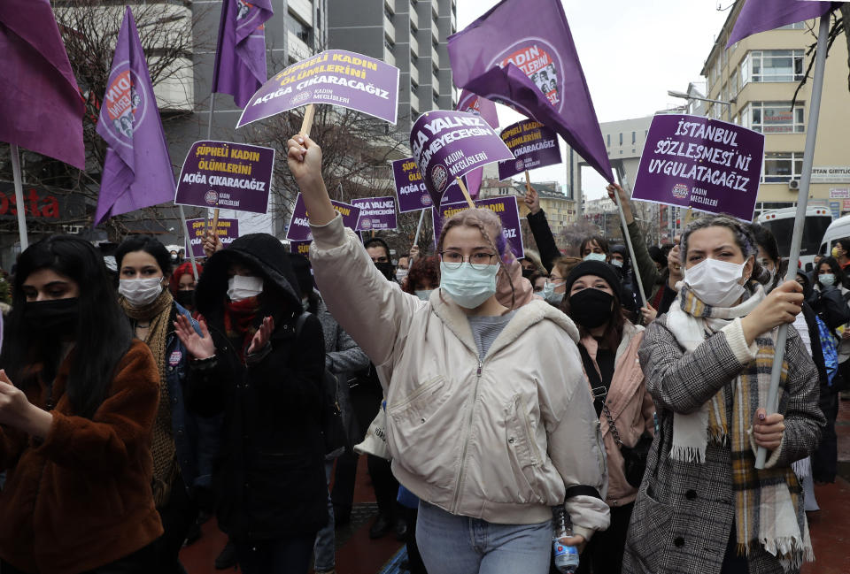 Women hold placards defending the Istanbul Convention during a protest rally in Ankara, Turkey, Saturday, March 20, 2021. Turkey withdrew early Saturday from a landmark European treaty protecting women from violence that it was the first country to sign 10 years ago and that bears the name of its largest city. President Recep Tayyip Erdogan's overnight decree annulling Turkey's ratification of the Istanbul Convention is a blow to women's rights advocates, who say the agreement is crucial to combating domestic violence. (AP Photo/Burhan Ozbilici)