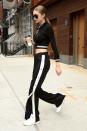 <p>In a cropped black and white track suit by Alessandra Rich, white Reebok sneakers and black Versace aviator sunglasses while leaving her apartment in NYC.</p>