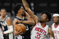 San Antonio Spurs forward Keldon Johnson (3) drives to the basket against Houston Rockets center Christian Wood (35) during the first half of an NBA basketball game in San Antonio, Thursday, Jan. 14, 2021. (AP Photo/Eric Gay)