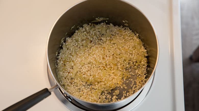 rice toasting in saucepan 