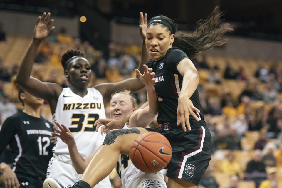 South Carolina's Victaria Saxton, right, fights off Missouri's Jordan Chavis, center, and Aijha Blackwell, left, for a rebound during the first half of an NCAA college basketball game Thursday, Jan. 16, 2020, in Columbia, Mo. (AP Photo/L.G. Patterson)