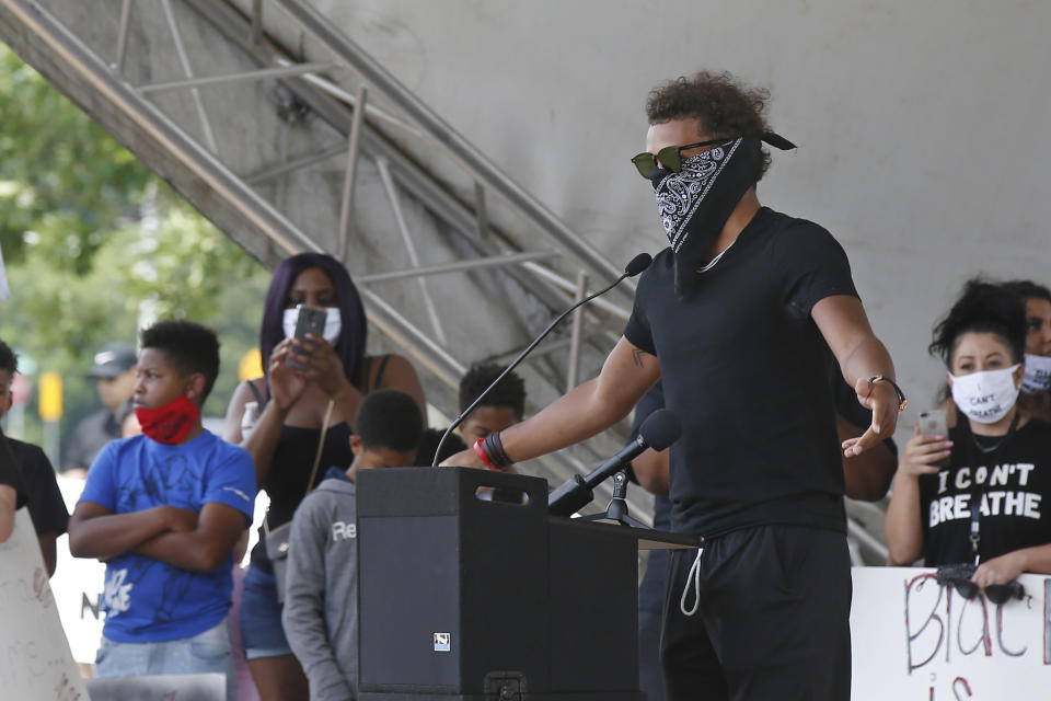 Atlanta Hawks guard Trae Young, right, speaks during a peaceful rally Monday, June 1, 2020, in his hometown of Norman, Okla., calling attention to the killing of George Floyd by Minneapolis police on May 25. (AP Photo/Sue Ogrocki)
