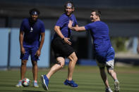 Los Angeles Dodgers' Walker Buehler, left and Clayton Kershaw play football before Game 4 of baseball's National League Championship Series between the Atlanta Braves and Los Angeles Dodgers, Wednesday, Oct. 20, 2021, in Los Angeles. (AP Photo/Jae Hong)