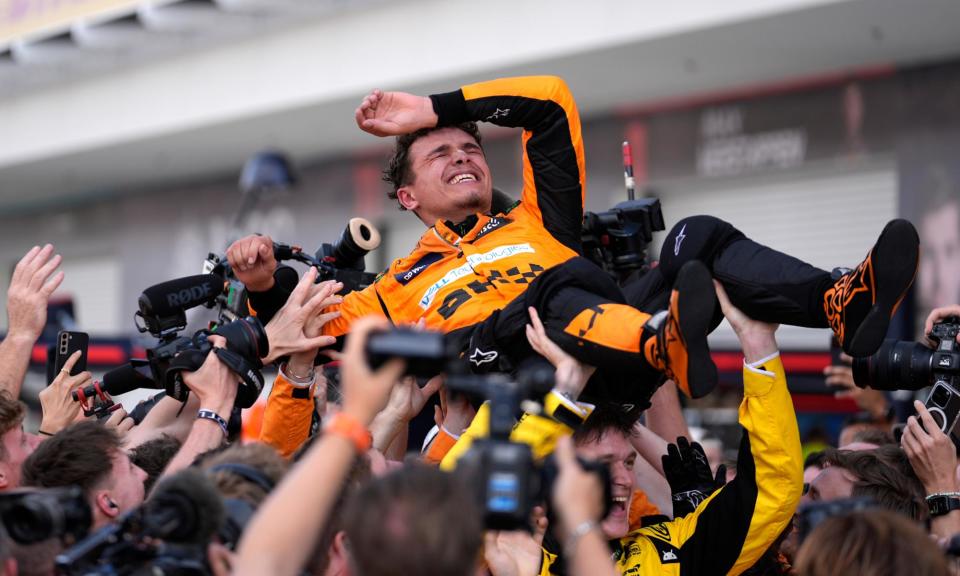 <span>Lando Norris into his McLaren team’s arms.</span><span>Photograph: Rebecca Blackwell/AP</span>