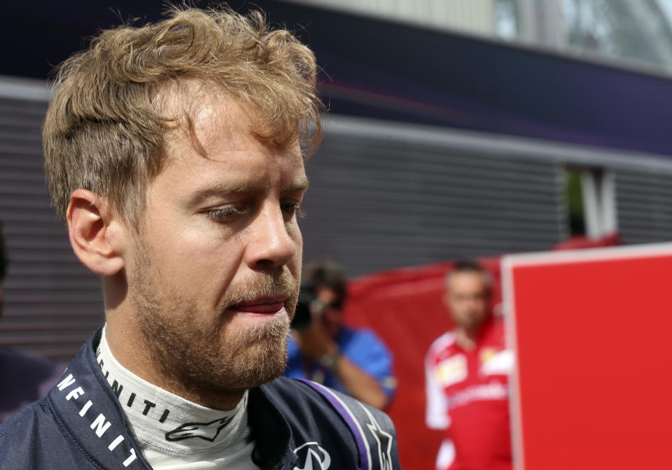 Red Bull driver Sebastian Vettel of Germany walks in the paddock prior to the start of the third practice session ahead of the Spain Formula One Grand Prix at the Barcelona Catalunya racetrack in Montmelo, near Barcelona, Spain, Saturday, May 10, 2014. Vettel's car rolled to a halt during Friday's first practice session, and it failed him again early in the third period of qualifying.(AP Photo/Luca Bruno)