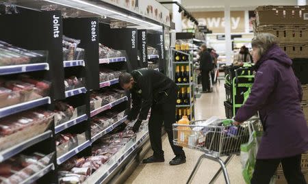 An employee tidies shelves at the Asda superstore in High Wycombe, Britain, February 8, 2017. REUTERS/Eddie Keogh