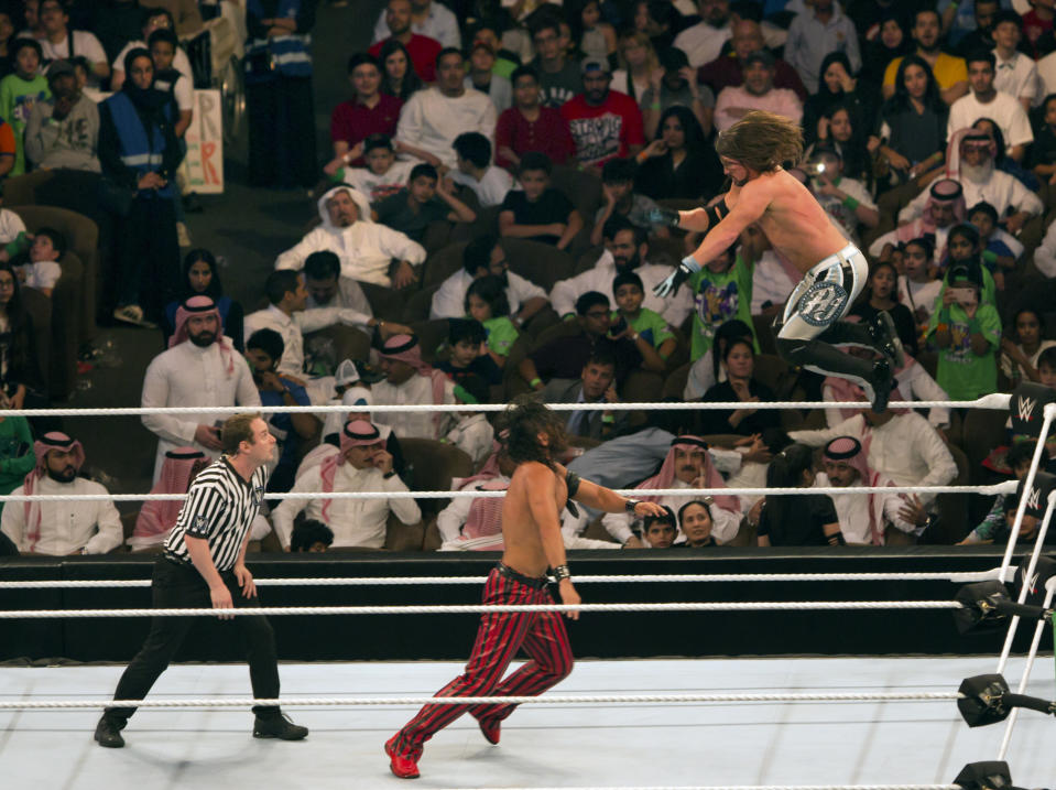 World Wrestling Entertainment stars AJ Styles, top, and Shinsuke Nakamura, wrestle during their match at the “Greatest Royal Rumble” event in Jiddah, Saudi Arabia, Friday, April 27, 2018. A previous WWE event held in the ultraconservative kingdom in 2014 was for men only. But Friday night’s event in Jiddah included both women and children in attendance. (AP Photo/Amr Nabil)