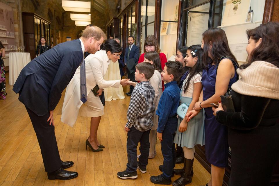 Meghan and Harry stopped to greet a group of excited children before attending a gala performance of <em>The Wider Earth</em> at the Natural History Museum in London in February.