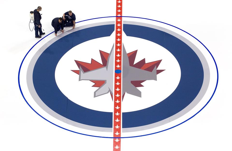 WINNIPEG, CANADA - JANUARY 8: Ice technicians install the Winnipeg Jets logo at centre ice at the MTS Centre on January 8, 2013 in Winnipeg, Manitoba, Canada. (Photo by Marianne Helm/Getty Images)