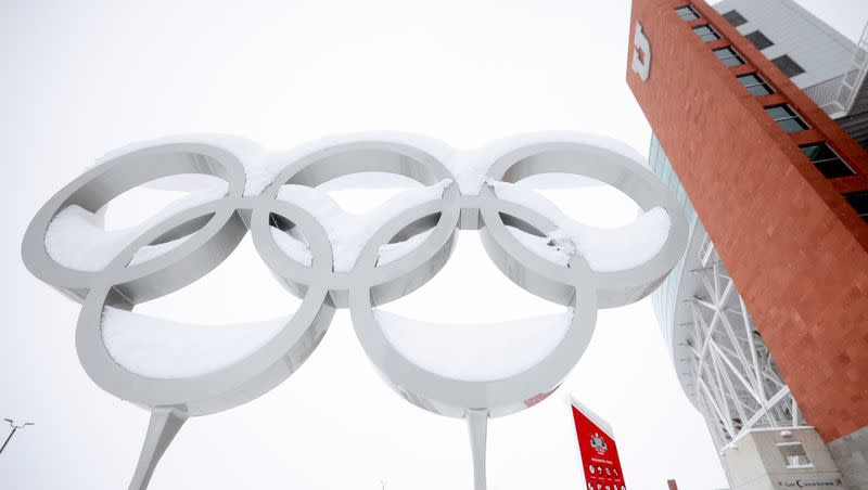 The Olympic rings are pictured covered in snow at the Olympic and Paralympic Cauldron Plaza in Salt Lake City, on Feb. 22, 2023.