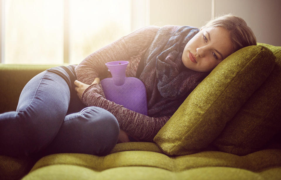 Pictured is a woman holding a hot water bottle, to illustrate an ACCC warning into the hidden dangers of hot water bottles.