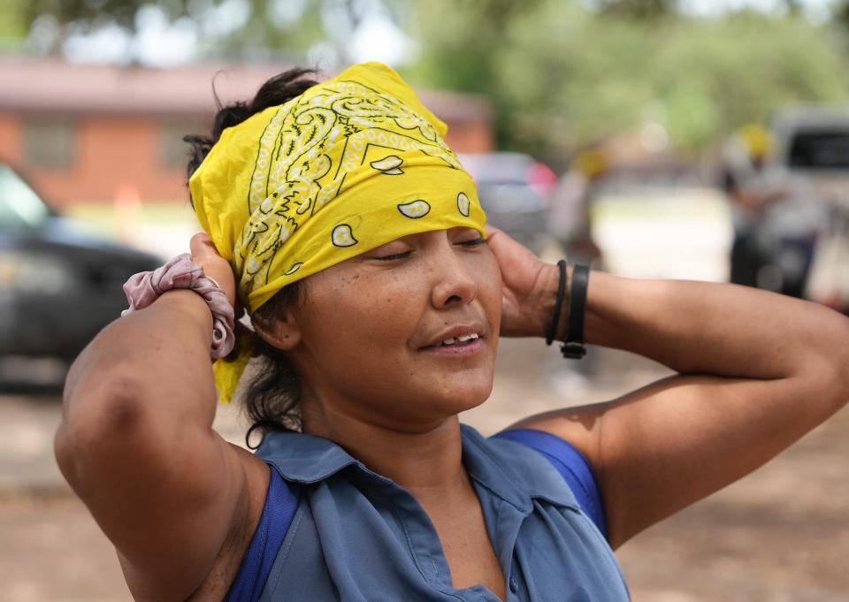 Margarita Ramos Castro cools off with an ice-cold bandana at the Sunrise Homeless Navigation Center in Austin last July during a heat advisory.