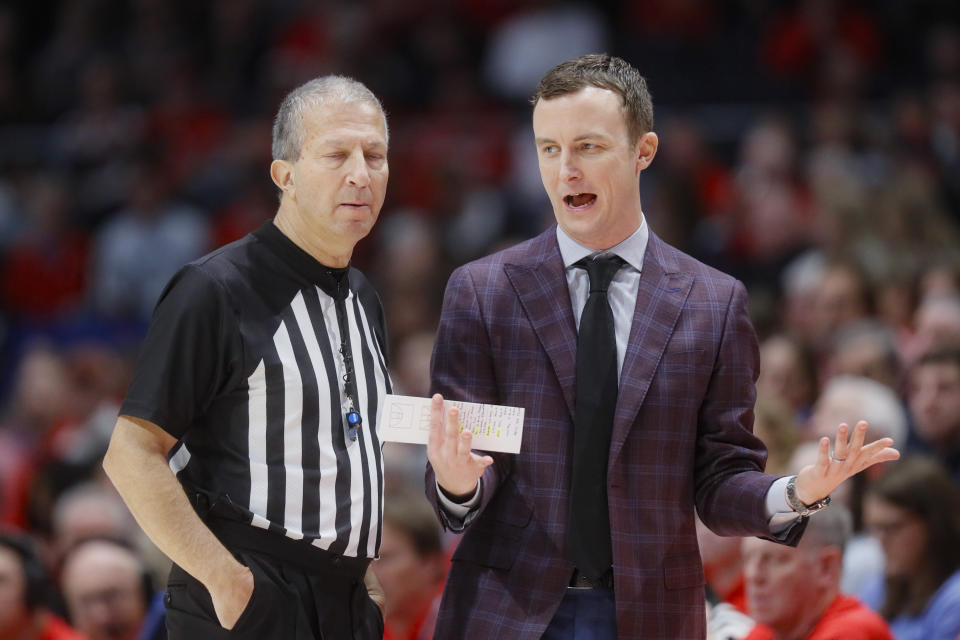 Massachusetts head coach Matt McCall, right, argues a call during the first half of an NCAA college basketball game against Dayton, Saturday, Jan. 11, 2020, in Dayton. (AP Photo/John Minchillo)